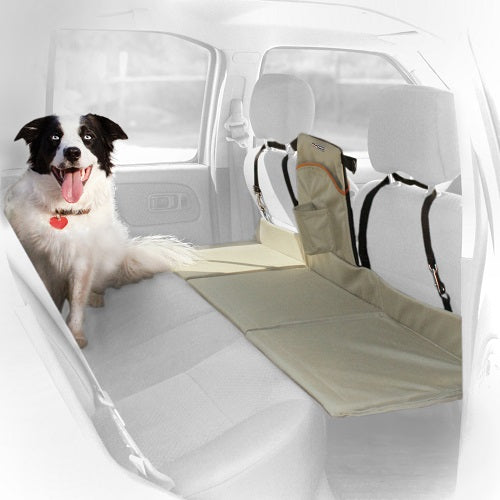 Dog sitting in back seat while dog bridge covers the floor of the back seat, giving the dog more room. 